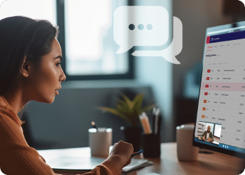 Person working on a computer with a messaging application open, featuring a chat bubble icon.